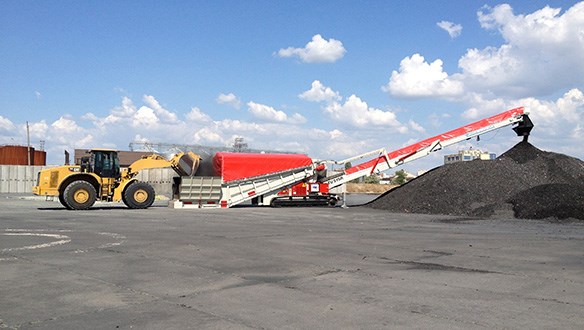 stockpiling coal from truck unloader